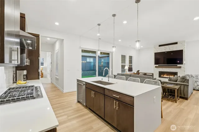 a large kitchen with kitchen island a sink stove and refrigerator