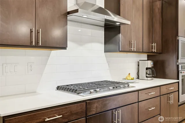 a kitchen with sink stove and cabinets