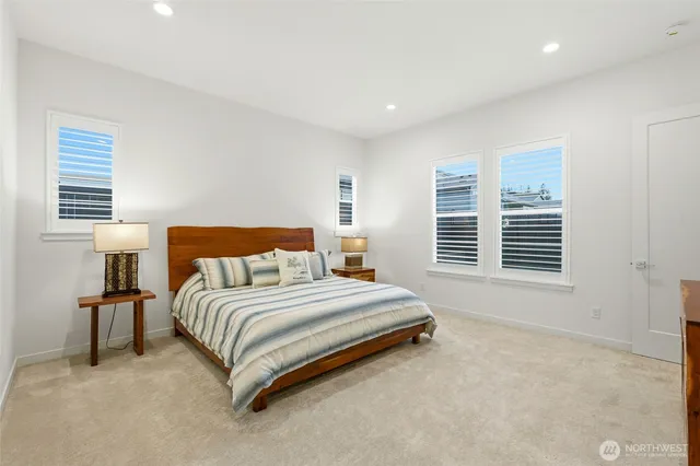 a spacious bedroom with a bed and a window