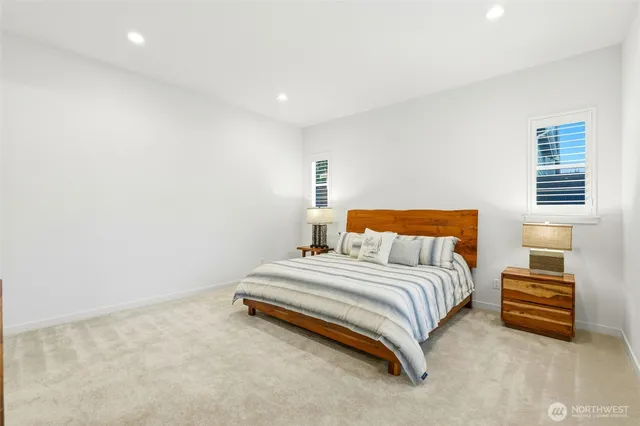 a spacious bedroom with a bed and a couch