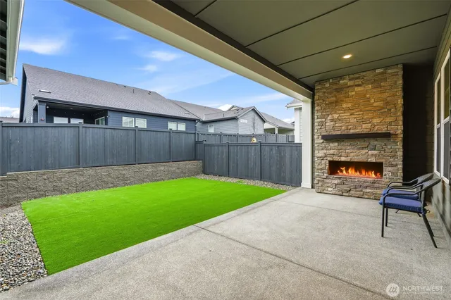 a view of backyard with seating area and green space