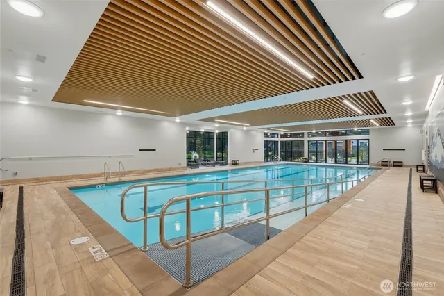 a view of a house with pool and wooden fence