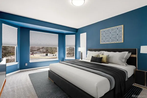 a bedroom with a large bed and a large window