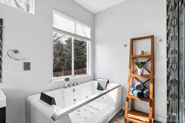 a bathroom with a bathtub and a window
