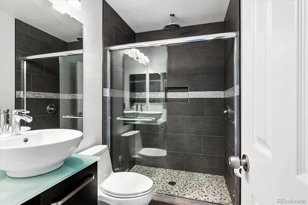 a bathroom with a toilet a sink and shower