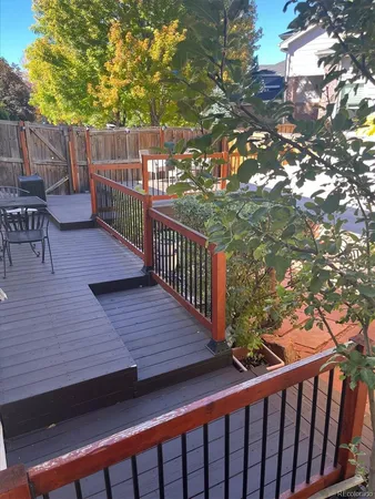 a view of a yard with yellow house