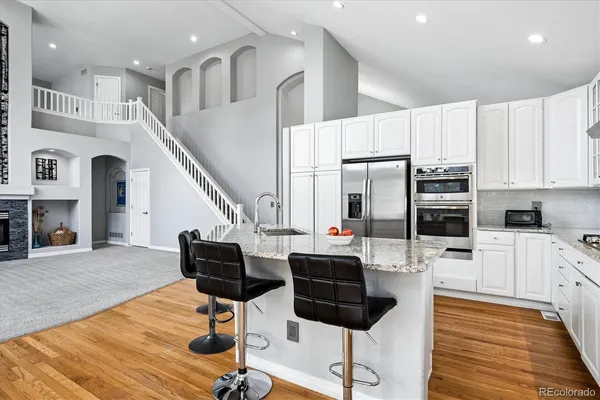 a living room with stainless steel appliances kitchen island granite countertop furniture and a kitchen view