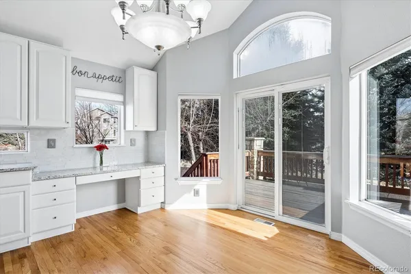 a view of a bedroom with wooden floor and windows