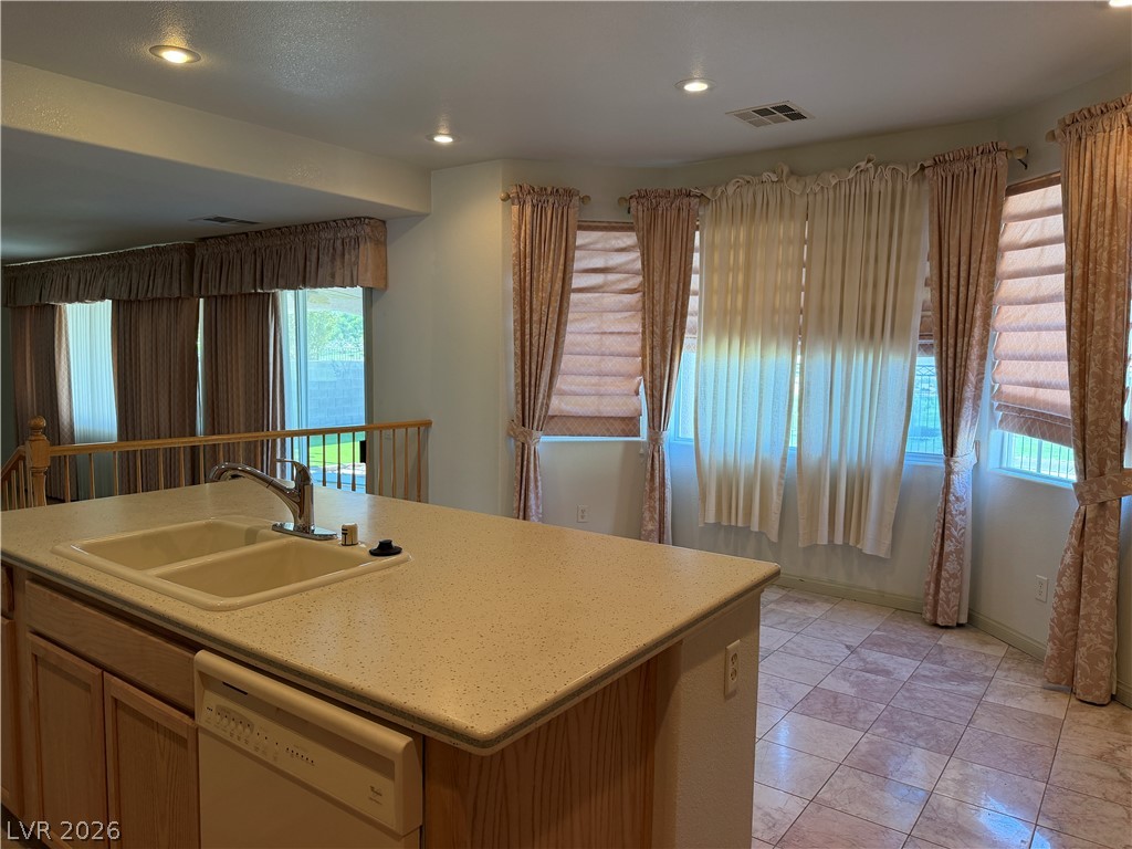 141 Rancho Maria Street Las Vegas, NV 89148 - Photo 11 of 30 Tiled flooring runs throughout this bright kitchen space featuring a functional center island.