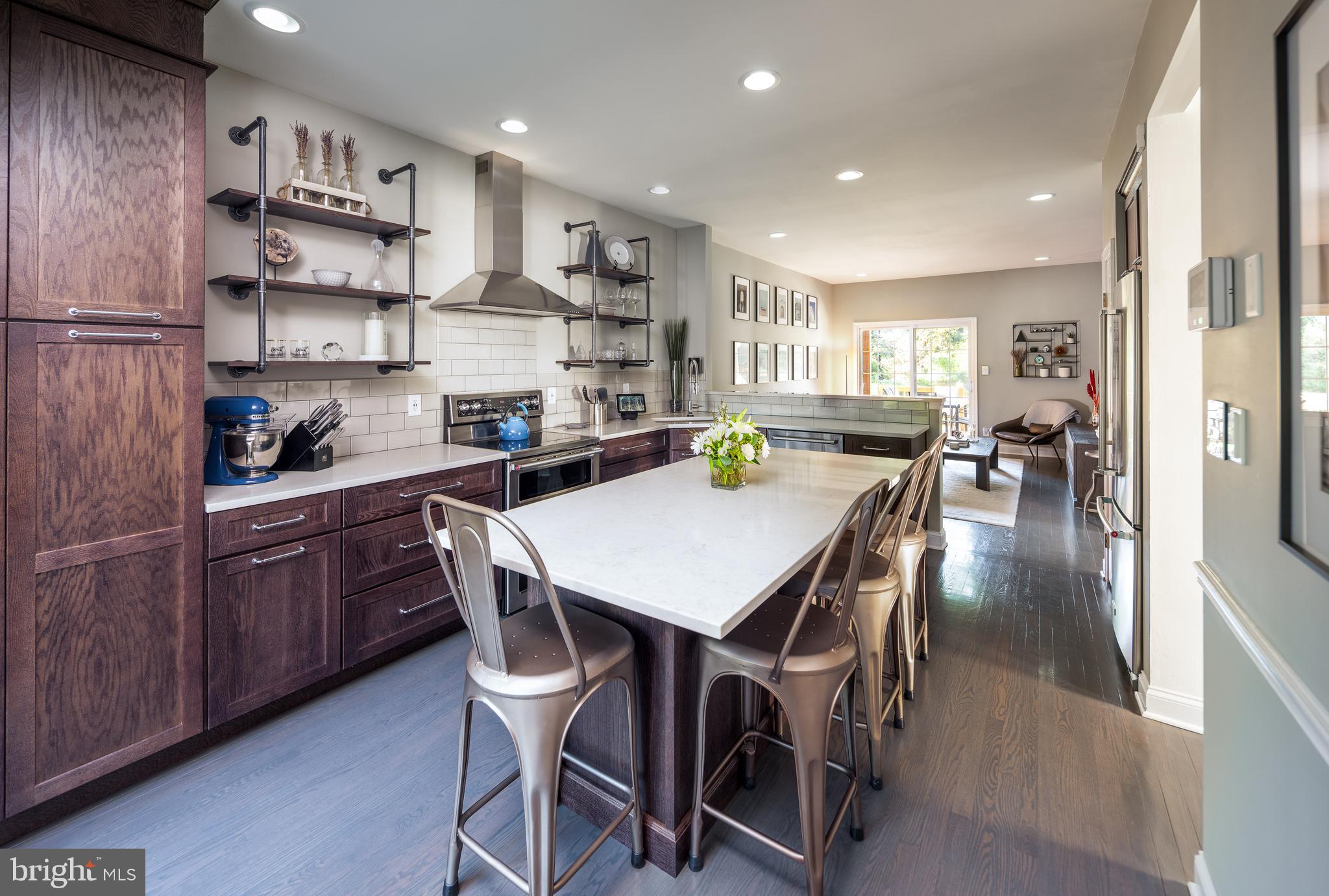 80 Dispatch Drive, Unit 97 Washington Crossing, PA 18977 - Photo 1 of 32 a kitchen with stainless steel appliances kitchen island granite countertop a sink a stove a dining table and chairs