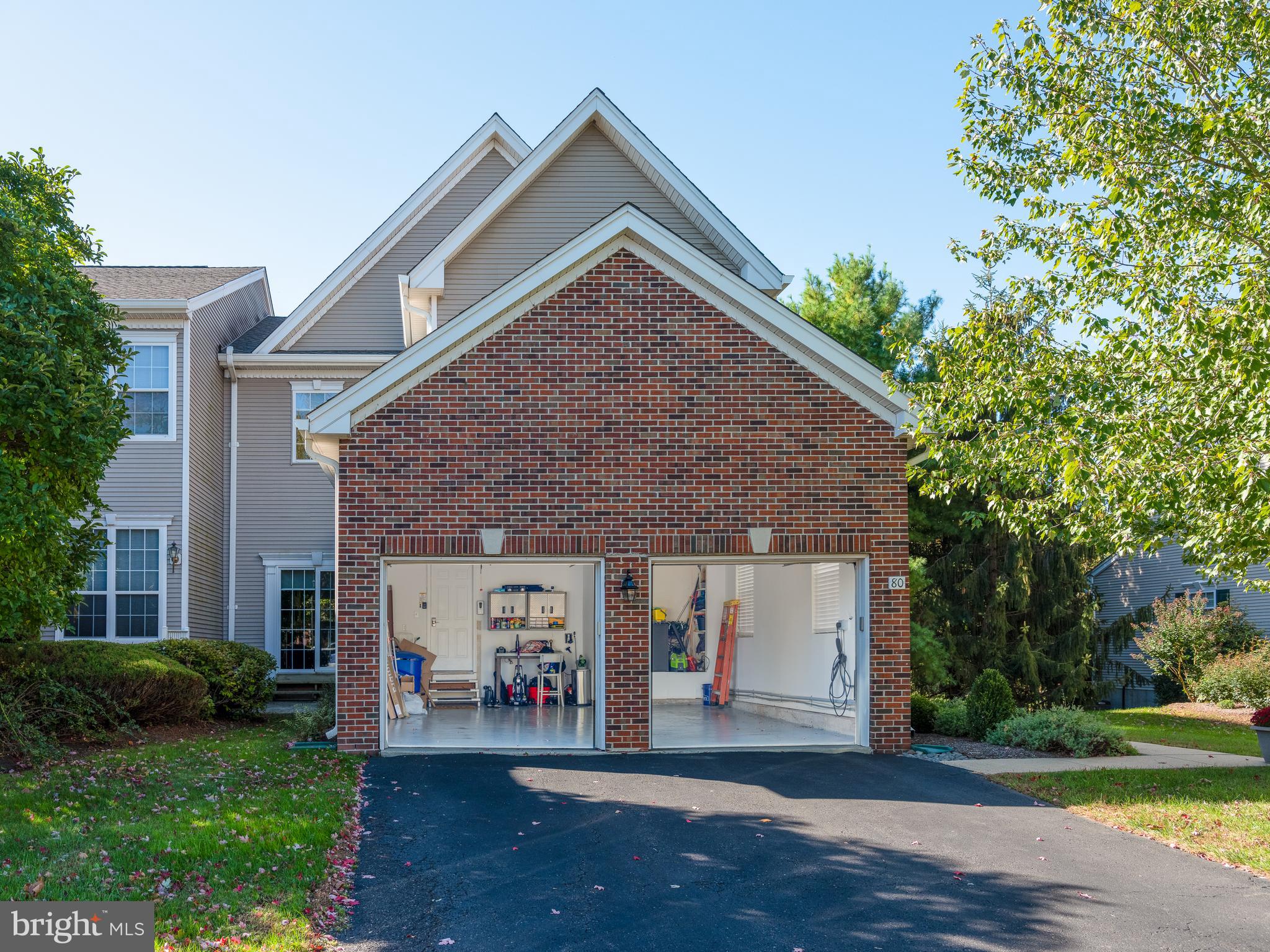 80 Dispatch Drive, Unit 97 Washington Crossing, PA 18977 - Photo 28 of 32 a front view of a house with a yard and garage