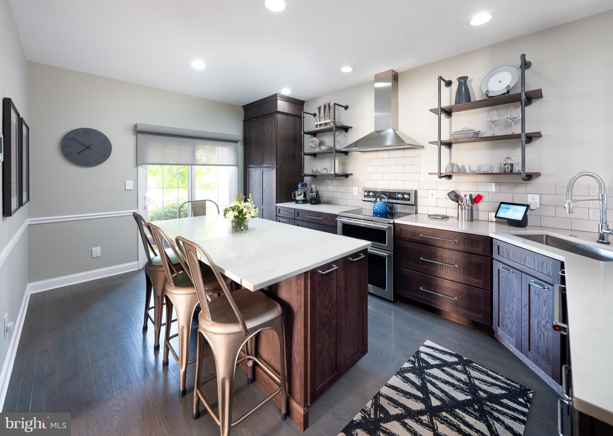 80 Dispatch Drive, Unit 97 Washington Crossing, PA 18977 - Photo 3 of 32 a kitchen with stainless steel appliances granite countertop a stove a refrigerator a sink dishwasher with a dining table and chairs