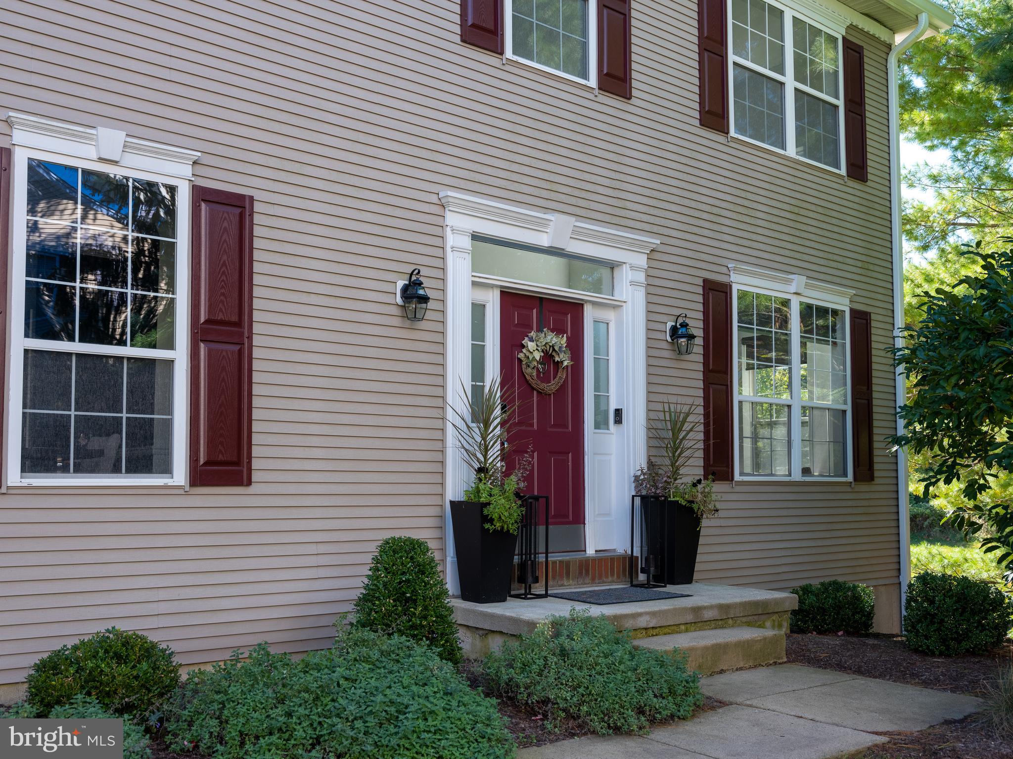 80 Dispatch Drive, Unit 97 Washington Crossing, PA 18977 - Photo 31 of 32 a front view of a house with a yard and potted plants