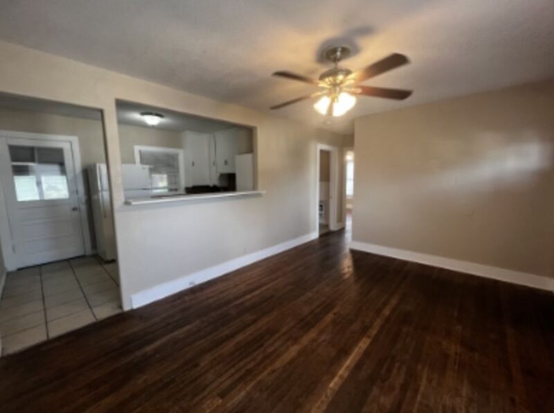 301 Cardinal Street San Marcos, TX 78666 - Photo 2 of 9 Unfurnished living room with dark wood-type flooring and ceiling fan