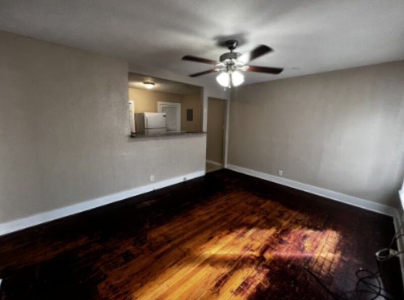 301 Cardinal Street San Marcos, TX 78666 - Photo 4 of 9 Unfurnished living room featuring dark wood-style floors and ceiling fan