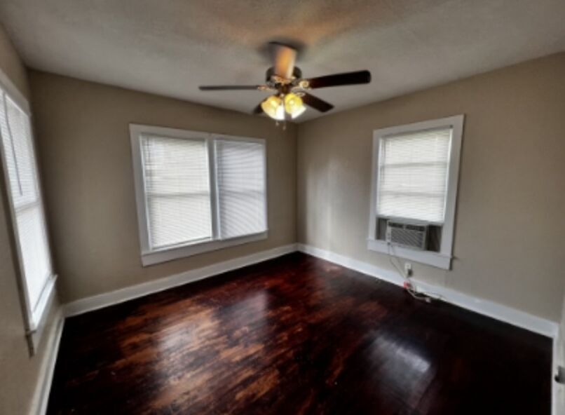 301 Cardinal Street San Marcos, TX 78666 - Photo 6 of 9 Empty room with dark wood-style flooring, cooling unit, and ceiling fan