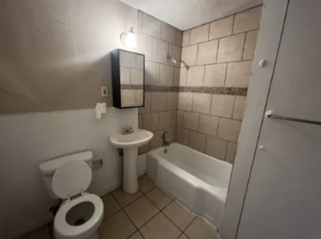 a bathroom with a toilet a sink and bathtub