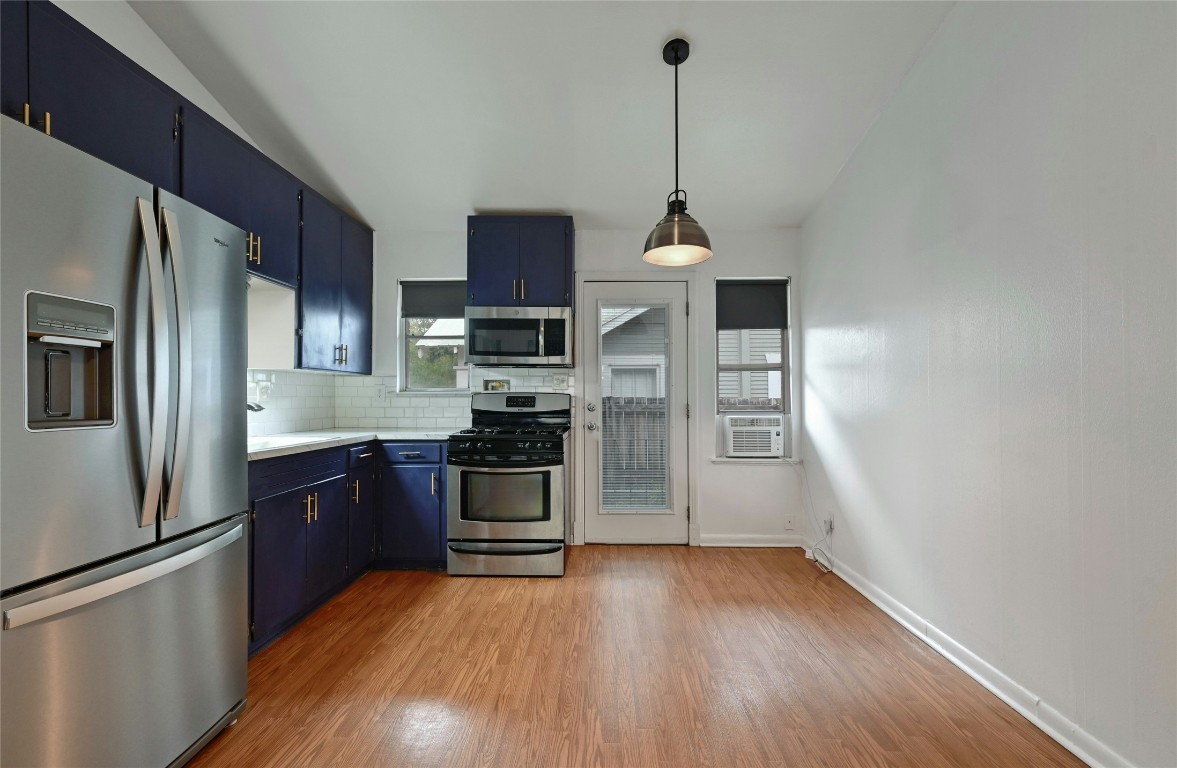 515 Pecan Grove Road, Unit A Austin, TX 78704 - Photo 7 of 17 a kitchen with stainless steel appliances granite countertop a refrigerator a stove top oven a sink and dishwasher