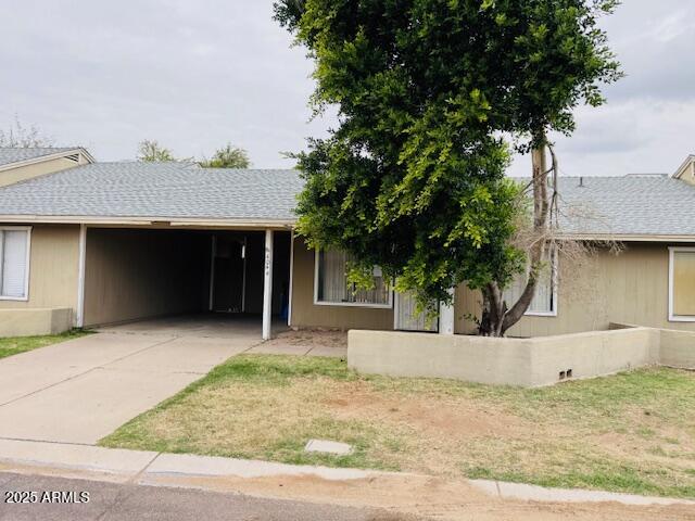 4044 East Carson Road Phoenix, AZ 85042 - Photo 2 of 22 a front view of a house with a yard and garage