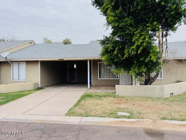 4044 East Carson Road Phoenix, AZ 85042 - Photo 3 of 22 a front view of a house with a yard and garage