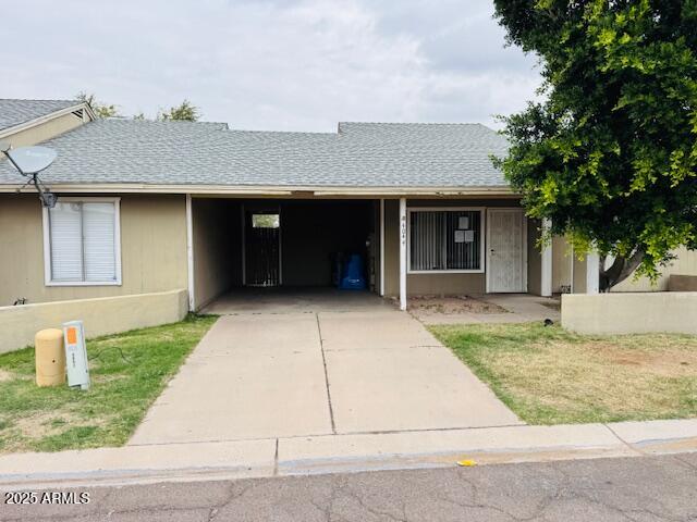 4044 East Carson Road Phoenix, AZ 85042 - Photo 4 of 22 a front view of a house with a garden