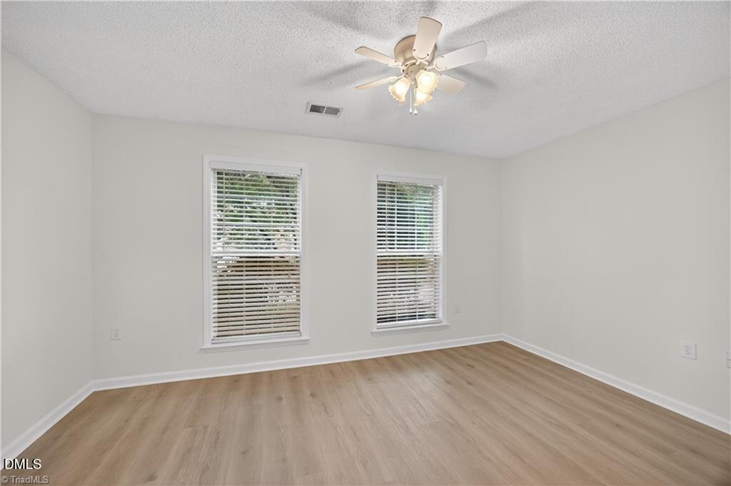 2221 Delaney Drive, Unit 114 Burlington, NC 27215 - Photo 12 of 18 an empty room with wooden floor and window