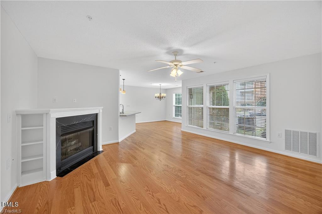 2221 Delaney Drive, Unit 114 Burlington, NC 27215 - Photo 3 of 18 a view of an empty room with wooden floor fireplace and a window