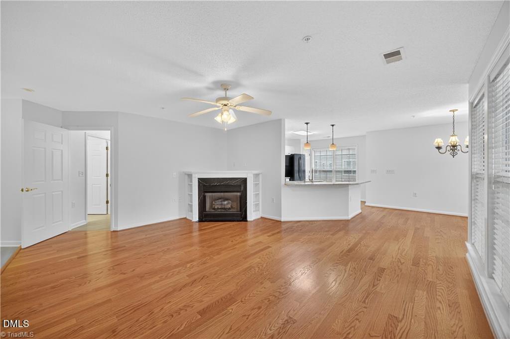 2221 Delaney Drive, Unit 114 Burlington, NC 27215 - Photo 4 of 18 a view of empty room with wooden floor and kitchen view