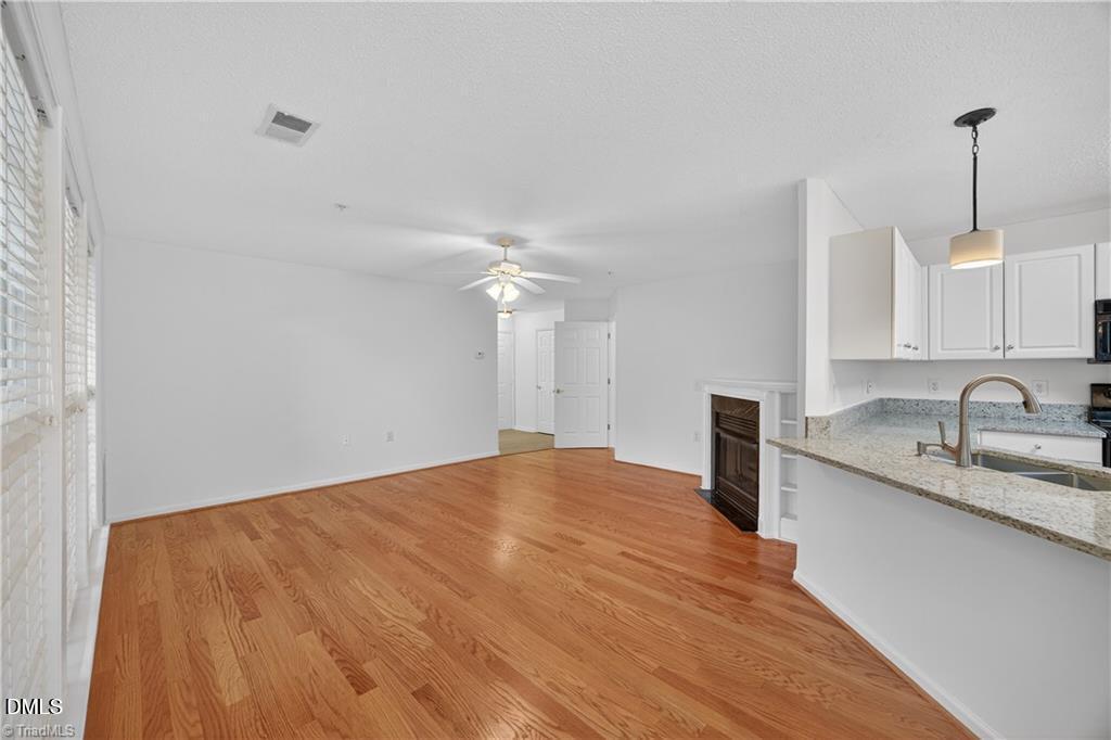 2221 Delaney Drive, Unit 114 Burlington, NC 27215 - Photo 6 of 18 a kitchen with granite countertop a sink cabinets and wooden floor