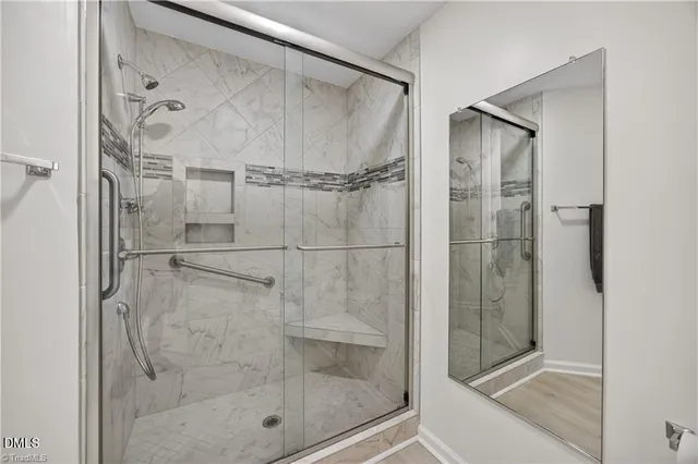 a bathroom with a glass shower door