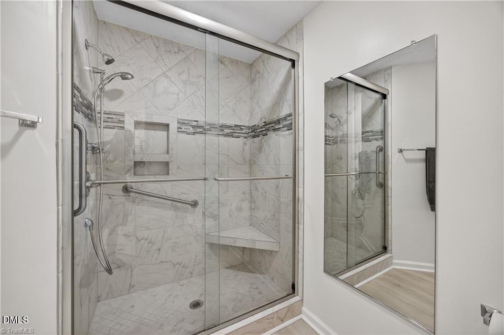 2221 Delaney Drive, Unit 114 Burlington, NC 27215 - Photo 8 of 18 a bathroom with a glass shower door