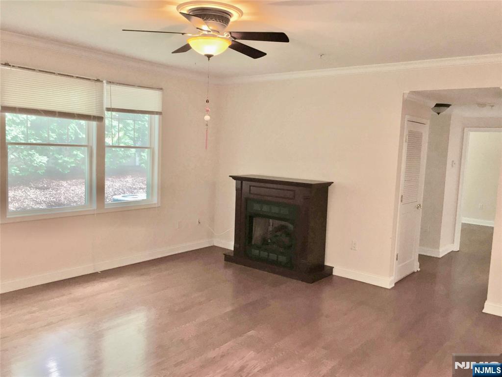 6 Hemlock Lane, Unit 6 Tenafly, NJ 07670 - Photo 4 of 9 an empty room with windows and fireplace
