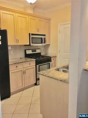 a kitchen with a sink stove and microwave