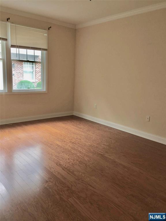 6 Hemlock Lane, Unit 6 Tenafly, NJ 07670 - Photo 8 of 9 an empty room with wooden floor and windows