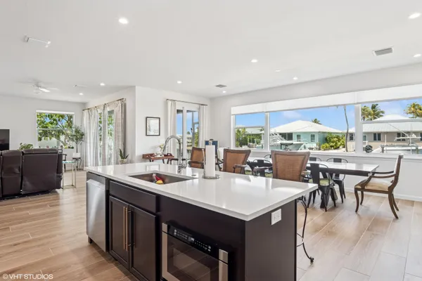 a dining room with stainless steel appliances a table and chairs