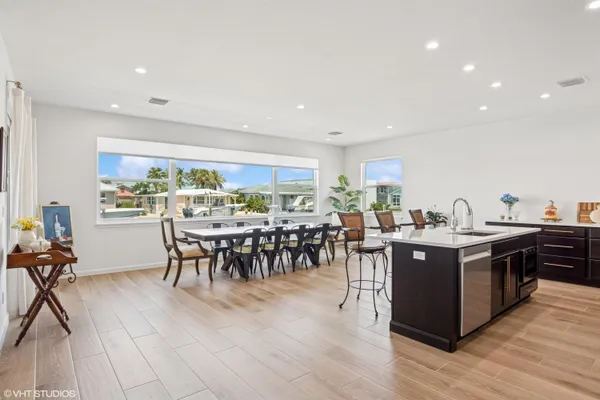 a dining room with furniture a window and wooden floor