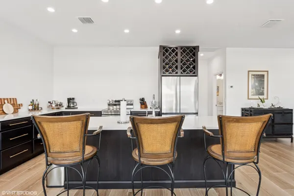 a dining room with furniture potted plants and wooden floor