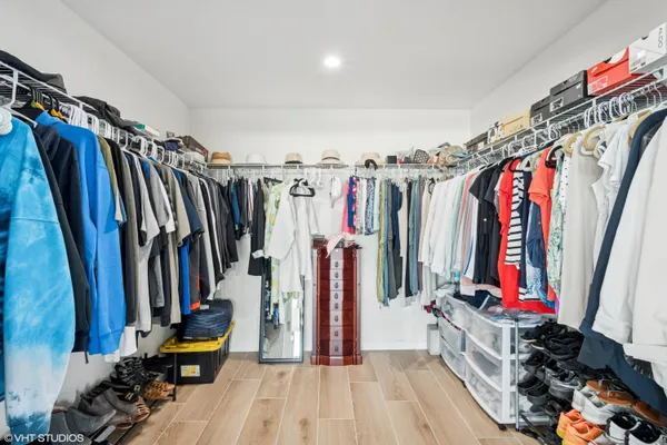 a bathroom with a tub double vanity sink and mirror