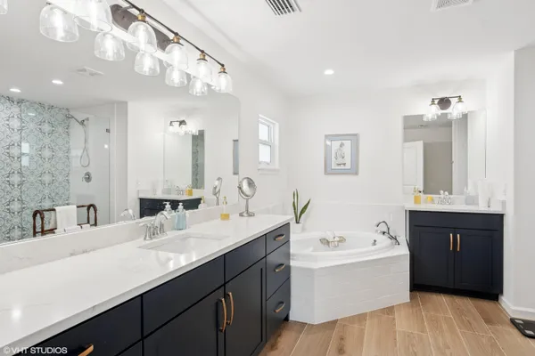 a bathroom with a bathtub a sink and a shower