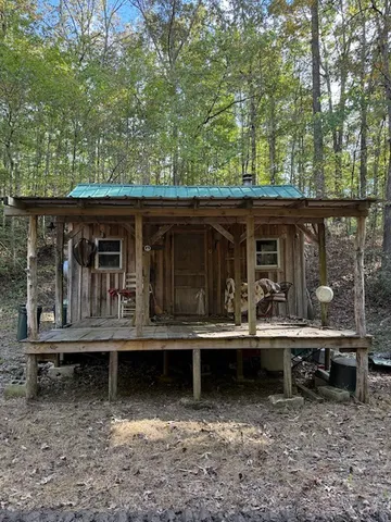 a backyard of a house with barbeque oven