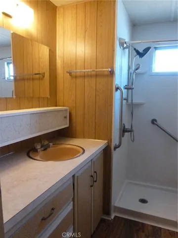 a bathroom with a tub a sink and shower