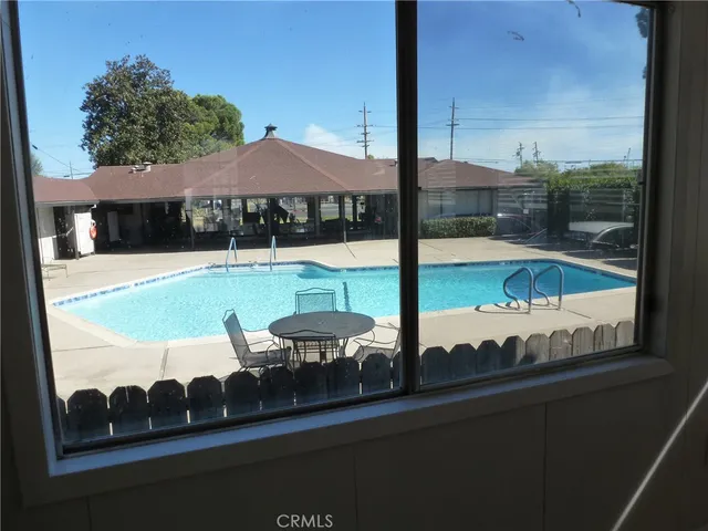 a view of a balcony with table and chairs under an umbrella