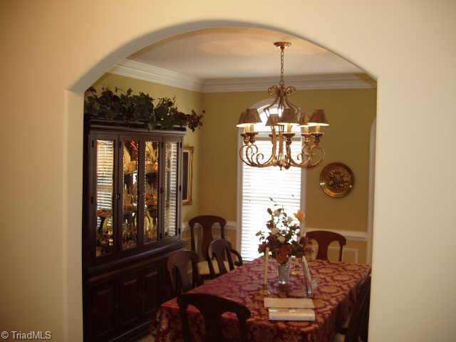 8204 Damson Court Oak Ridge, NC 27310 - Photo 3 of 7 Other. Elegant dining room with wainscotting and arched doorways