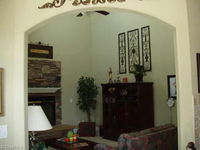 8204 Damson Court Oak Ridge, NC 27310 - Photo 5 of 7 Other. Family room view from kitchen. Oversized gas fireplace w/stone surround and raised stone hearth, blower and remote control. Vaulted ceiling with skylights. Audio pre-wire.