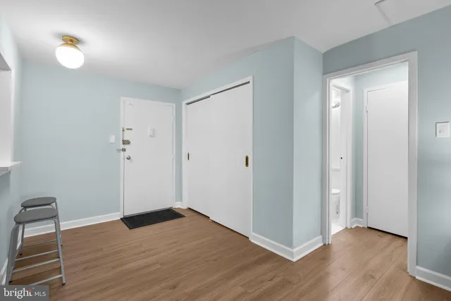 a view of empty room with wooden floor