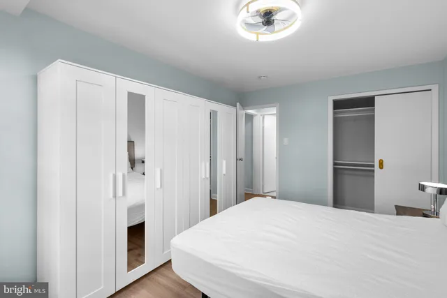 a bedroom with a bed and a chandelier