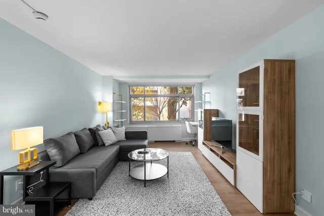 a living room with furniture and a large window