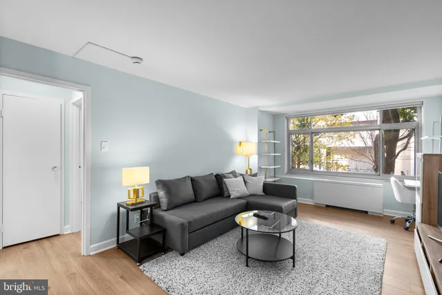 a living room with furniture and a large window