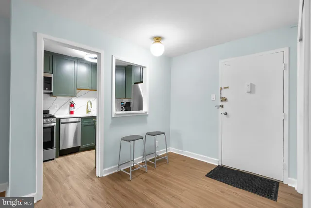 a very nice looking room with wooden floor and white walls