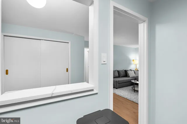 a en suite bathroom with a granite countertop sink and a mirror